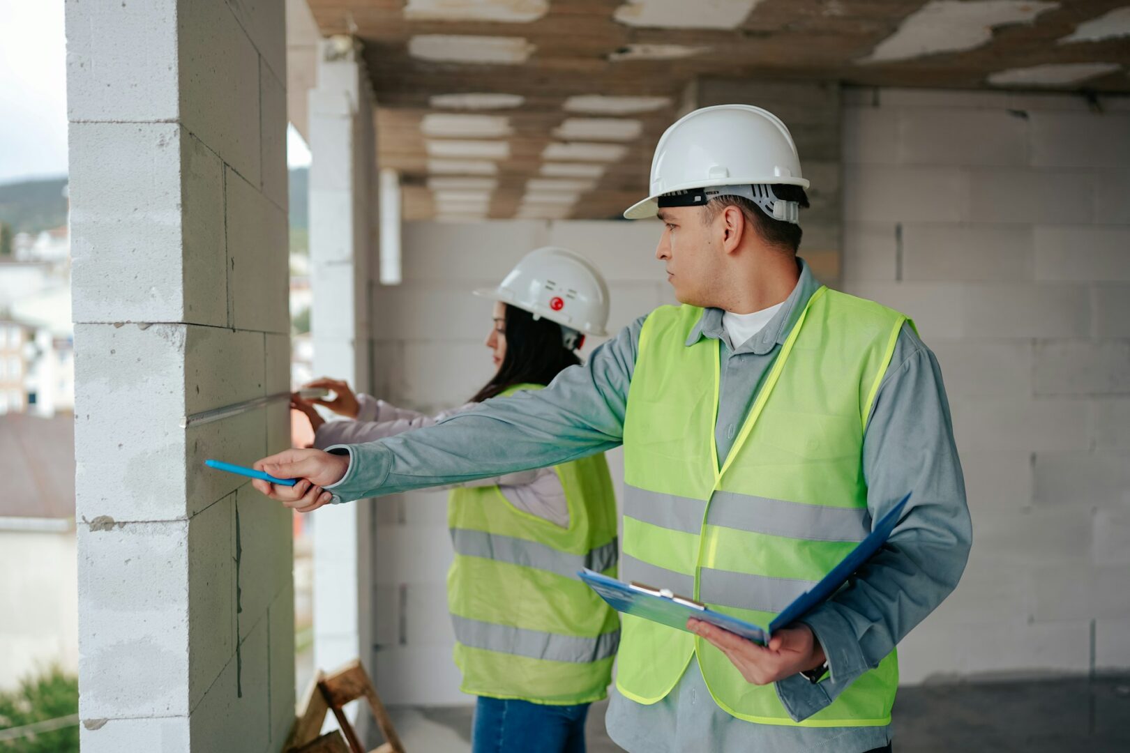 two persons inspecting the building